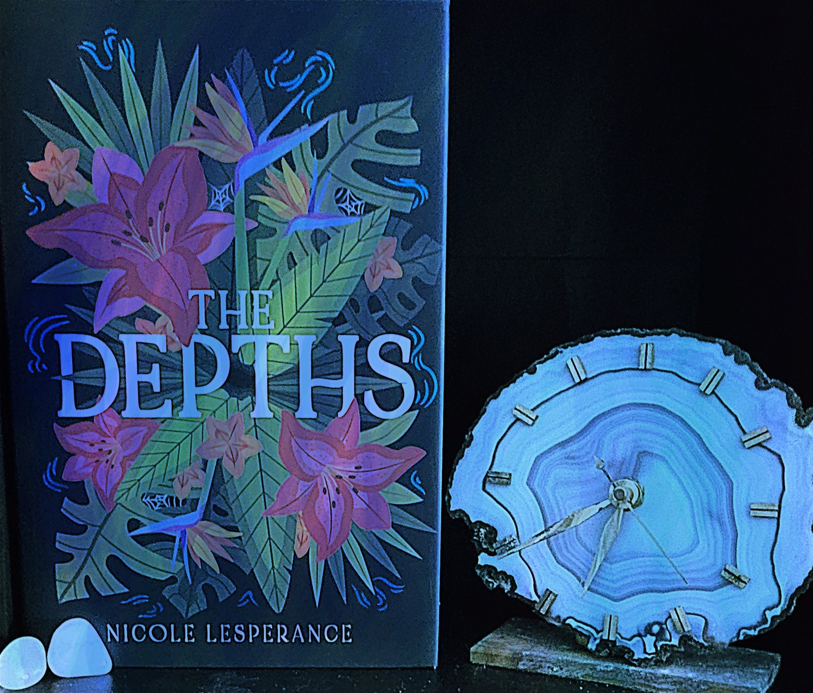 The Depths book, framed by a geode clock.